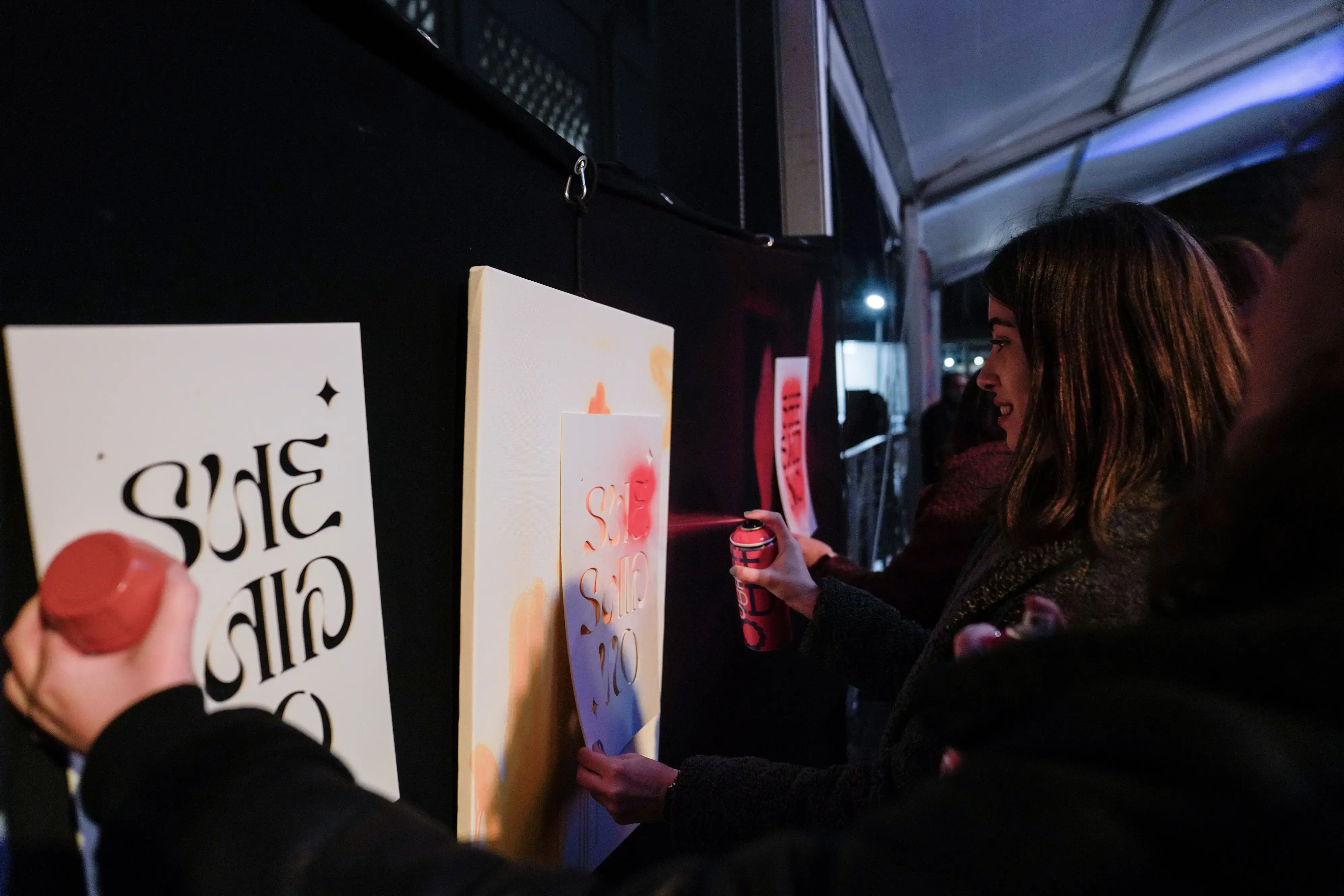 Participants are painting #SheSaidNo stencils. Photo: UN Women/İlkin Eskipehlivan.